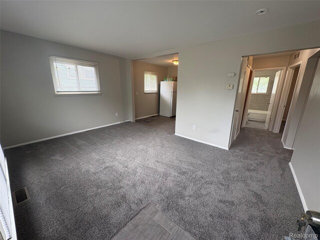 565 Wyoming Ave, Pontiac, MI 48341 - spare room with baseboards and carpet floors