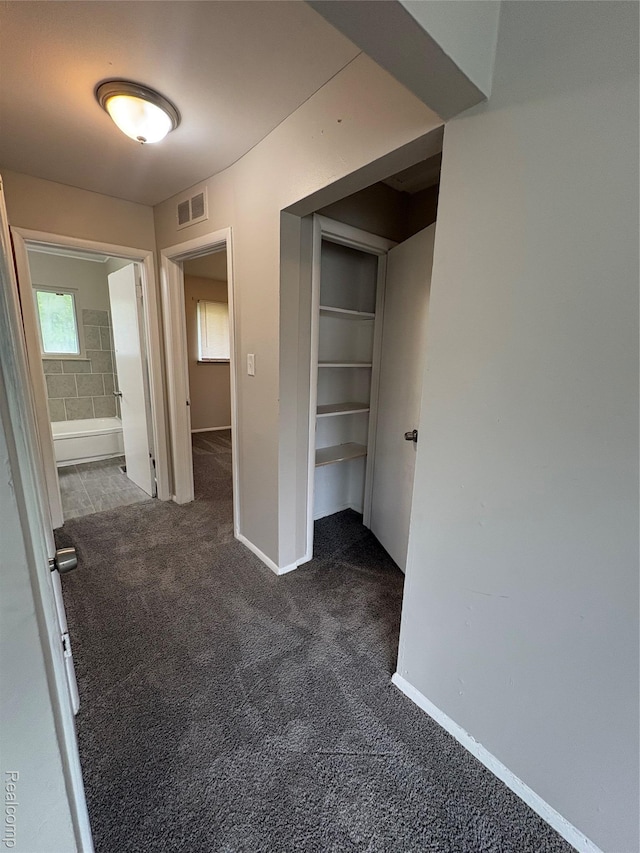 565 Wyoming Ave, Pontiac, MI 48341 - corridor featuring dark carpet and baseboards