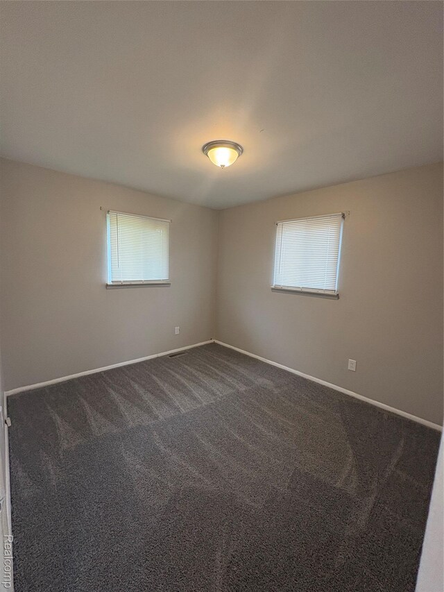 565 Wyoming Ave, Pontiac, MI 48341 - unfurnished room with plenty of natural light and dark carpet