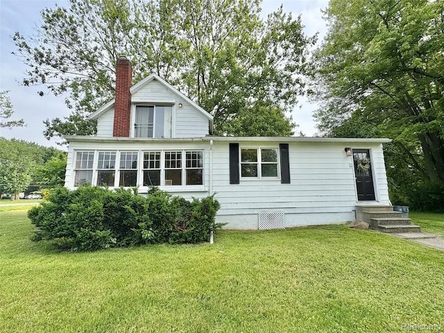 7073 N Linden Rd, Mount Morris, MI 48458 - view of front of home with a chimney, a front lawn, and entry steps