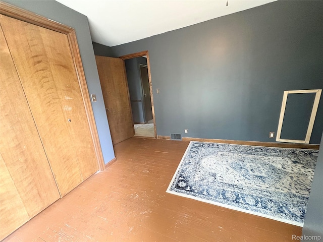 7073 N Linden Rd, Mount Morris, MI 48458 - unfurnished bedroom with wood finished floors and baseboards