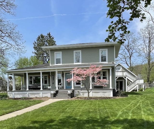 307 N Jefferson St SE, Lowell, MI 49331 - view of front of property with a porch, a front lawn, and stairs