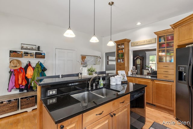 307 N Jefferson St SE, Lowell, MI 49331 - kitchen featuring black appliances, a kitchen island with sink, light wood-style floors, glass insert cabinets, and recessed lighting