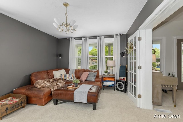 307 N Jefferson St SE, Lowell, MI 49331 - carpeted living room featuring a chandelier
