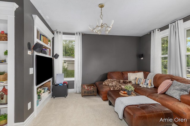 307 N Jefferson St SE, Lowell, MI 49331 - carpeted living room featuring a chandelier and baseboards