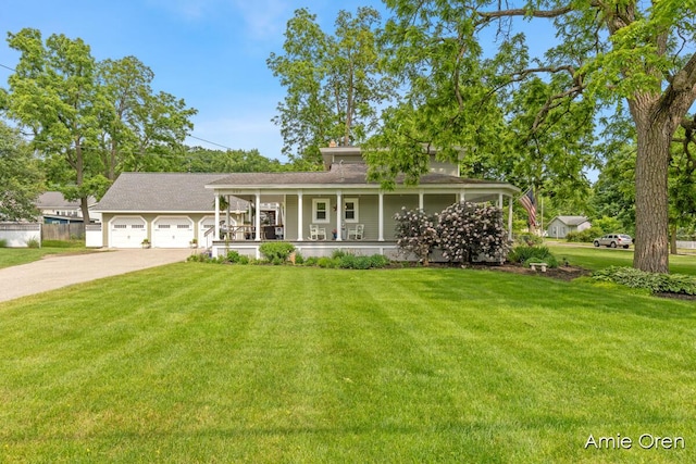 307 N Jefferson St SE, Lowell, MI 49331 - view of front facade with a porch, concrete driveway, a front yard, and a garage