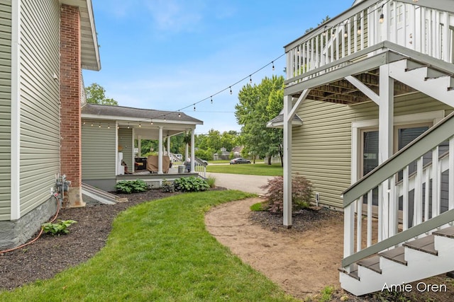 307 N Jefferson St SE, Lowell, MI 49331 - view of grassy yard featuring a porch