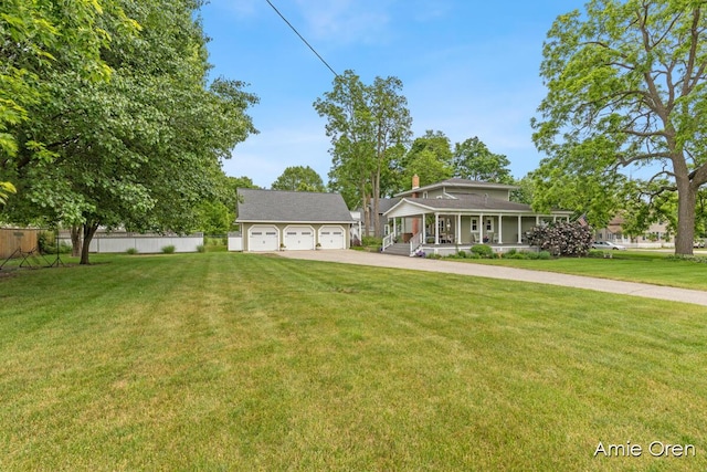 307 N Jefferson St SE, Lowell, MI 49331 - view of front of house with covered porch, an outdoor structure, and a detached garage