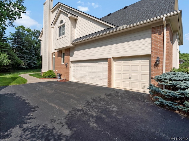7304 Colchester Ln, West Bloomfield, MI 48322 - view of home's exterior featuring brick siding, asphalt driveway, a chimney, and a shingled roof