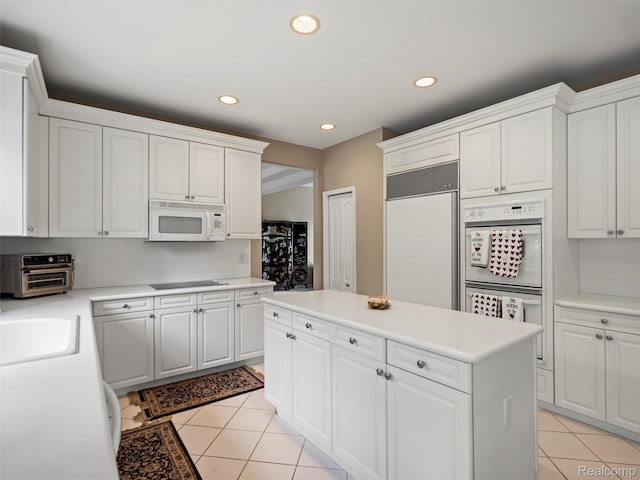 7304 Colchester Ln, West Bloomfield, MI 48322 - kitchen with white appliances, light tile patterned flooring, recessed lighting, light countertops, and white cabinetry