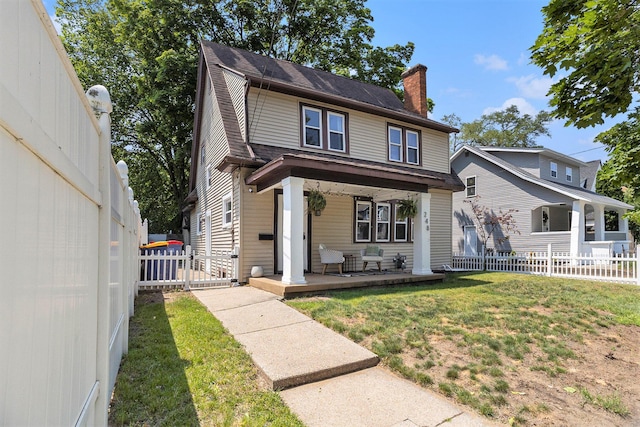1248 Fisk Rd SE, Grand Rapids, MI 49506 - view of front of home featuring a porch, a chimney, and a shingled roof