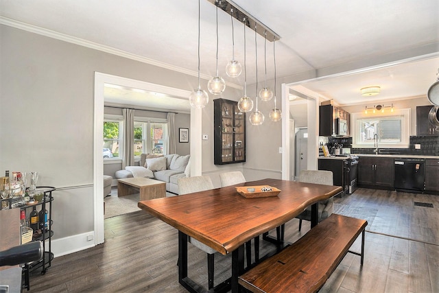 1248 Fisk Rd SE, Grand Rapids, MI 49506 - dining space with dark wood-style floors and ornamental molding