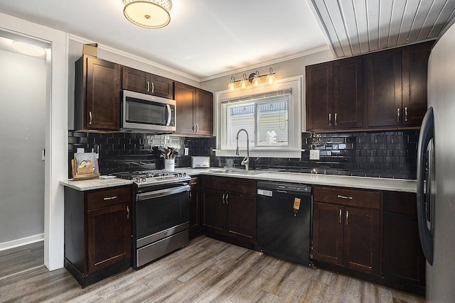 1248 Fisk Rd SE, Grand Rapids, MI 49506 - kitchen with appliances with stainless steel finishes, light countertops, decorative backsplash, and dark brown cabinets