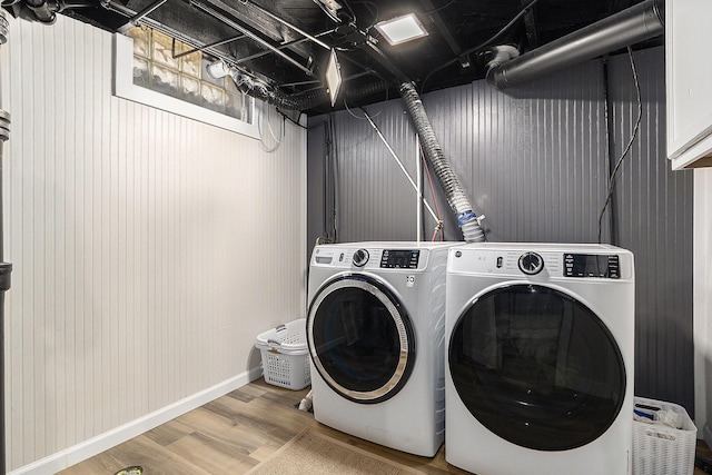 1248 Fisk Rd SE, Grand Rapids, MI 49506 - washroom with washing machine and dryer and wood finished floors