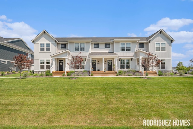 6678 S Square Ln, Rockford, MI 49341 - view of front of property with board and batten siding, covered porch, and a front lawn