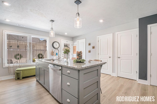 6678 S Square Ln, Rockford, MI 49341 - kitchen featuring gray cabinets, stainless steel dishwasher, a textured ceiling, light wood finished floors, and an island with sink