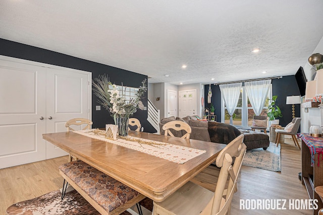 6678 S Square Ln, Rockford, MI 49341 - dining space with light wood finished floors, a textured ceiling, stairs, and recessed lighting