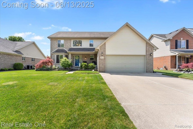 26957 Blue Heron Dr, Flat Rock, MI 48134 - traditional home with driveway, an attached garage, a front lawn, and brick siding