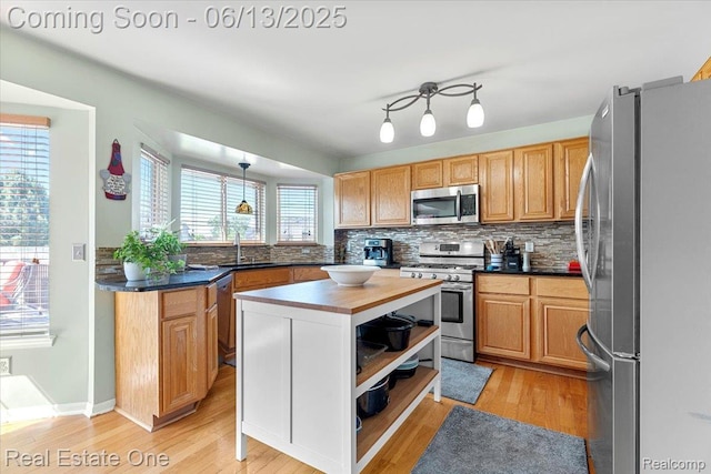 26957 Blue Heron Dr, Flat Rock, MI 48134 - kitchen with stainless steel appliances, light wood-style floors, backsplash, open shelves, and a center island