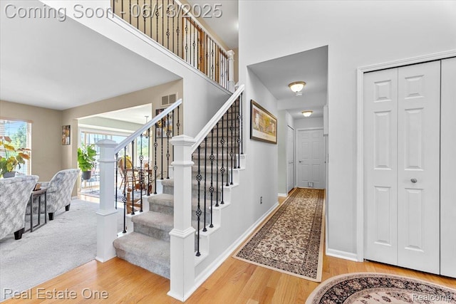 26957 Blue Heron Dr, Flat Rock, MI 48134 - stairway with wood finished floors and a high ceiling