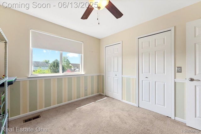 26957 Blue Heron Dr, Flat Rock, MI 48134 - unfurnished bedroom with carpet floors, multiple closets, and ceiling fan