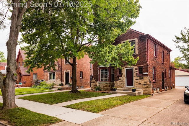 3924 Yorkshire Rd, Detroit, MI 48224 - view of front of house with a front lawn, brick siding, an outdoor structure, and a garage