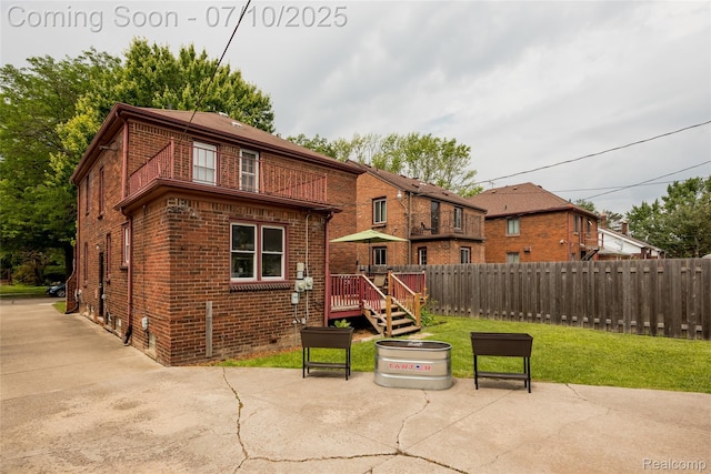 3924 Yorkshire Rd, Detroit, MI 48224 - rear view of house featuring brick siding, a patio, and a wooden deck