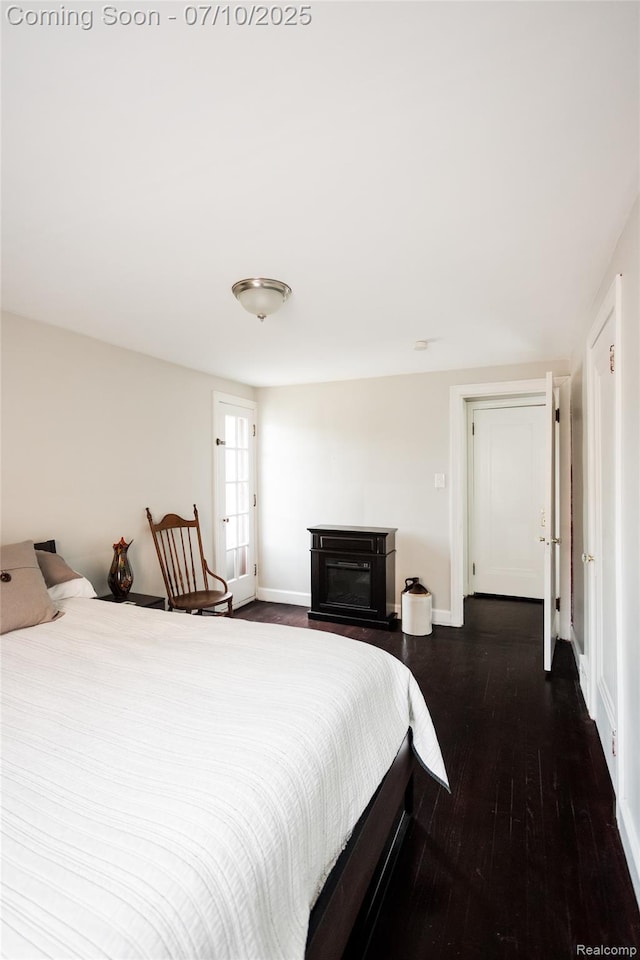 3924 Yorkshire Rd, Detroit, MI 48224 - bedroom with dark wood-style floors and a glass covered fireplace