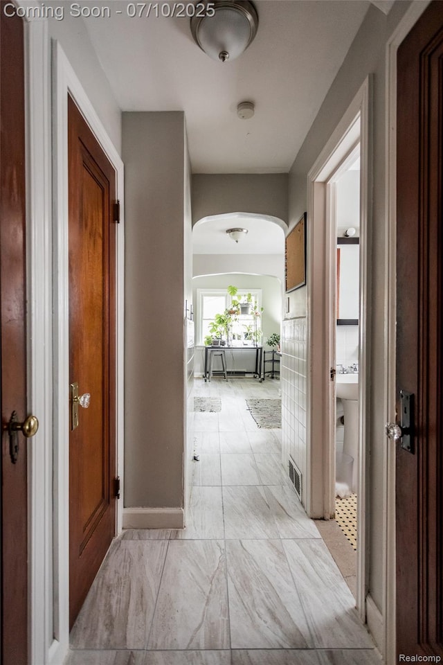 3924 Yorkshire Rd, Detroit, MI 48224 - corridor with arched walkways and light marble finish flooring