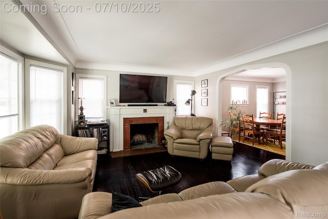 3924 Yorkshire Rd, Detroit, MI 48224 - living room with arched walkways, dark wood-style flooring, and a brick fireplace