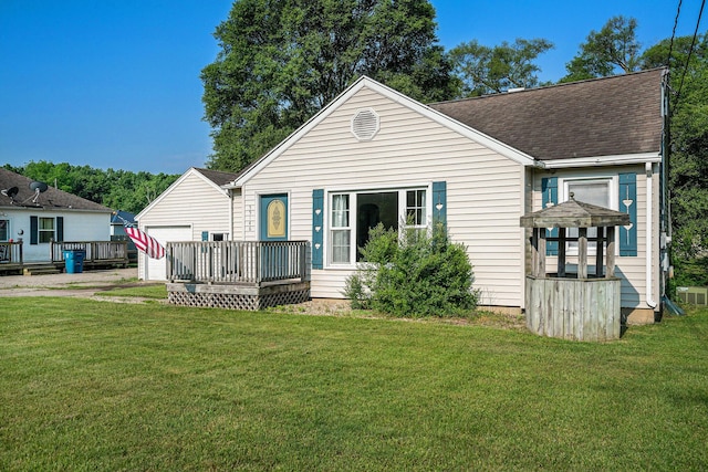 55146 M 51 N, Dowagiac, MI 49047 - back of property featuring a deck, a lawn, roof with shingles, and a garage