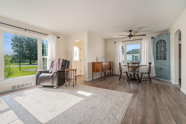 55146 M 51 N, Dowagiac, MI 49047 - sitting room featuring arched walkways, dark wood-style flooring, ceiling fan, and a textured ceiling