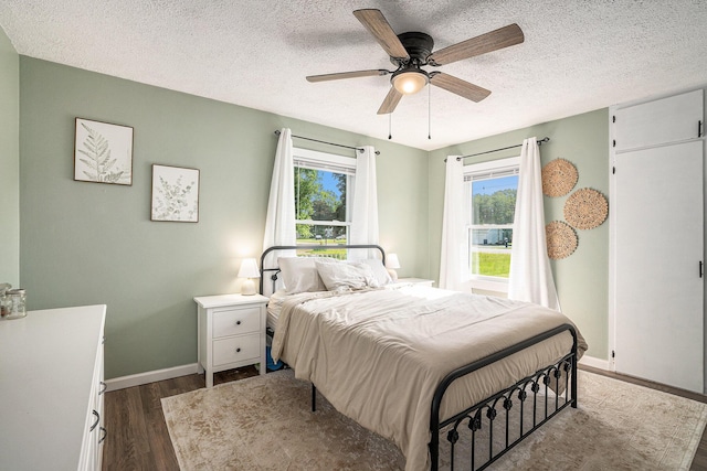 55146 M 51 N, Dowagiac, MI 49047 - bedroom with dark wood-style flooring, a textured ceiling, and a ceiling fan