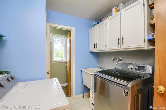 1038 Cora Dr, Flint, MI 48532 - laundry room featuring washer and dryer and cabinet space
