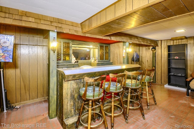 1038 Cora Dr, Flint, MI 48532 - indoor bar featuring wood walls and brick flooring