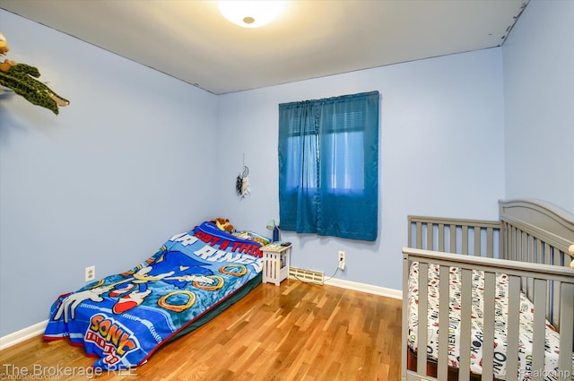 1038 Cora Dr, Flint, MI 48532 - bedroom featuring wood finished floors and baseboards