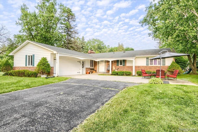 1038 Cora Dr, Flint, MI 48532 - single story home with brick siding, a garage, driveway, and a front yard