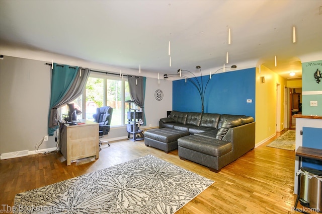 1038 Cora Dr, Flint, MI 48532 - living room featuring light wood finished floors and baseboards