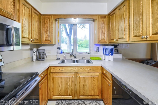 1038 Cora Dr, Flint, MI 48532 - kitchen with range with electric cooktop, stainless steel microwave, dishwasher, light countertops, and brown cabinets