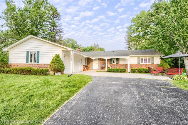 1038 Cora Dr, Flint, MI 48532 - single story home with brick siding, an attached garage, driveway, a front lawn, and a chimney