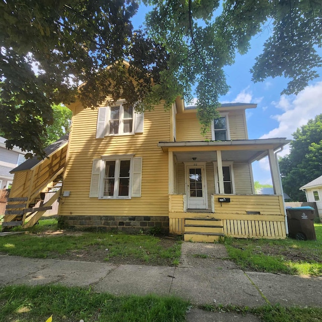212 W Ash St, Albion, MI 49224 - view of front of house featuring covered porch and stairway