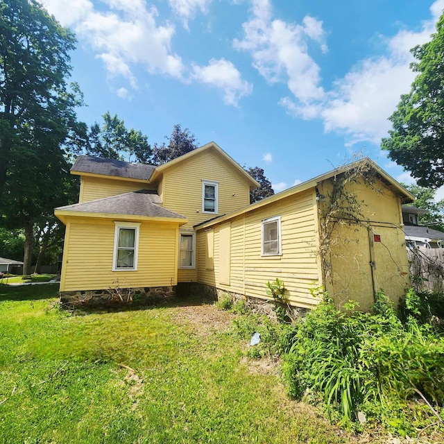 212 W Ash St, Albion, MI 49224 - rear view of house featuring a lawn and crawl space