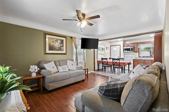 2009 Thomas St, Lincoln Park, MI 48146 - living room with a ceiling fan, healthy amount of natural light, and dark wood-style flooring