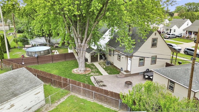 2009 Thomas St, Lincoln Park, MI 48146 - rear view of property featuring a fenced backyard, a shingled roof, and a patio area