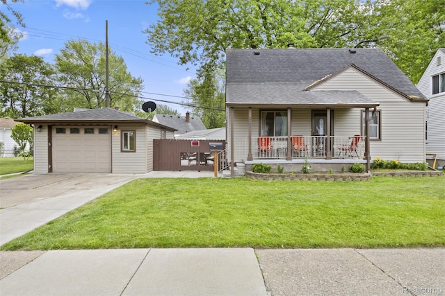 2009 Thomas St, Lincoln Park, MI 48146 - view of front of home featuring a porch, a garage, driveway, and a shingled roof