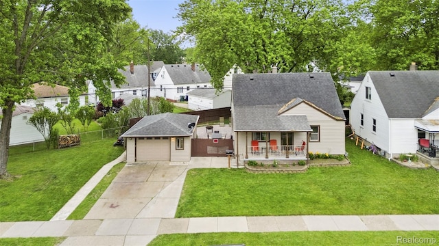 2009 Thomas St, Lincoln Park, MI 48146 - view of front of home featuring covered porch, roof with shingles, a residential view, and driveway