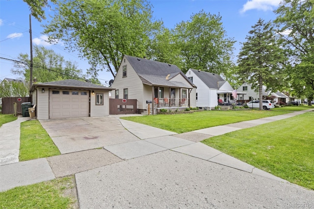 2009 Thomas St, Lincoln Park, MI 48146 - view of front of home featuring covered porch, driveway, an outdoor structure, a garage, and a front lawn