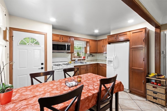 2009 Thomas St, Lincoln Park, MI 48146 - kitchen with white appliances, healthy amount of natural light, light countertops, light tile patterned flooring, and recessed lighting