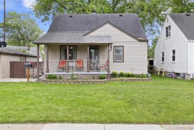 2009 Thomas St, Lincoln Park, MI 48146 - view of front of property featuring covered porch, a shingled roof, and a front yard