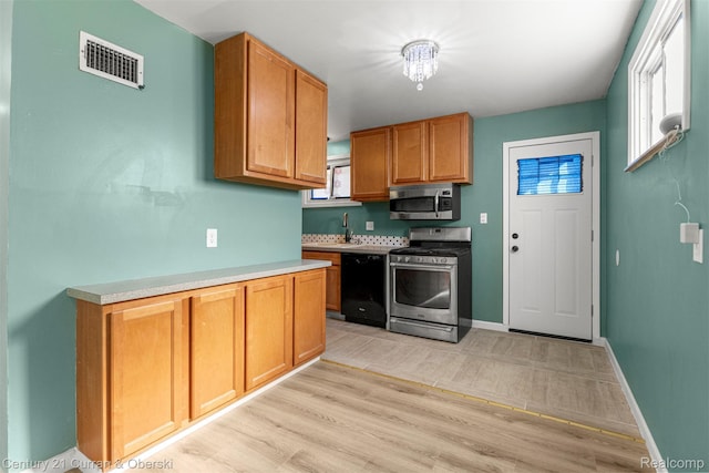 17295 Dora St, Melvindale, MI 48122 - kitchen with appliances with stainless steel finishes, light wood-style floors, and light countertops